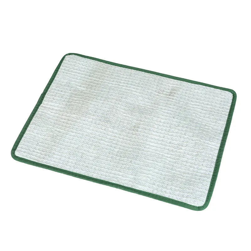 Green washable dog grass pee mat with realistic lawn texture on a patio.