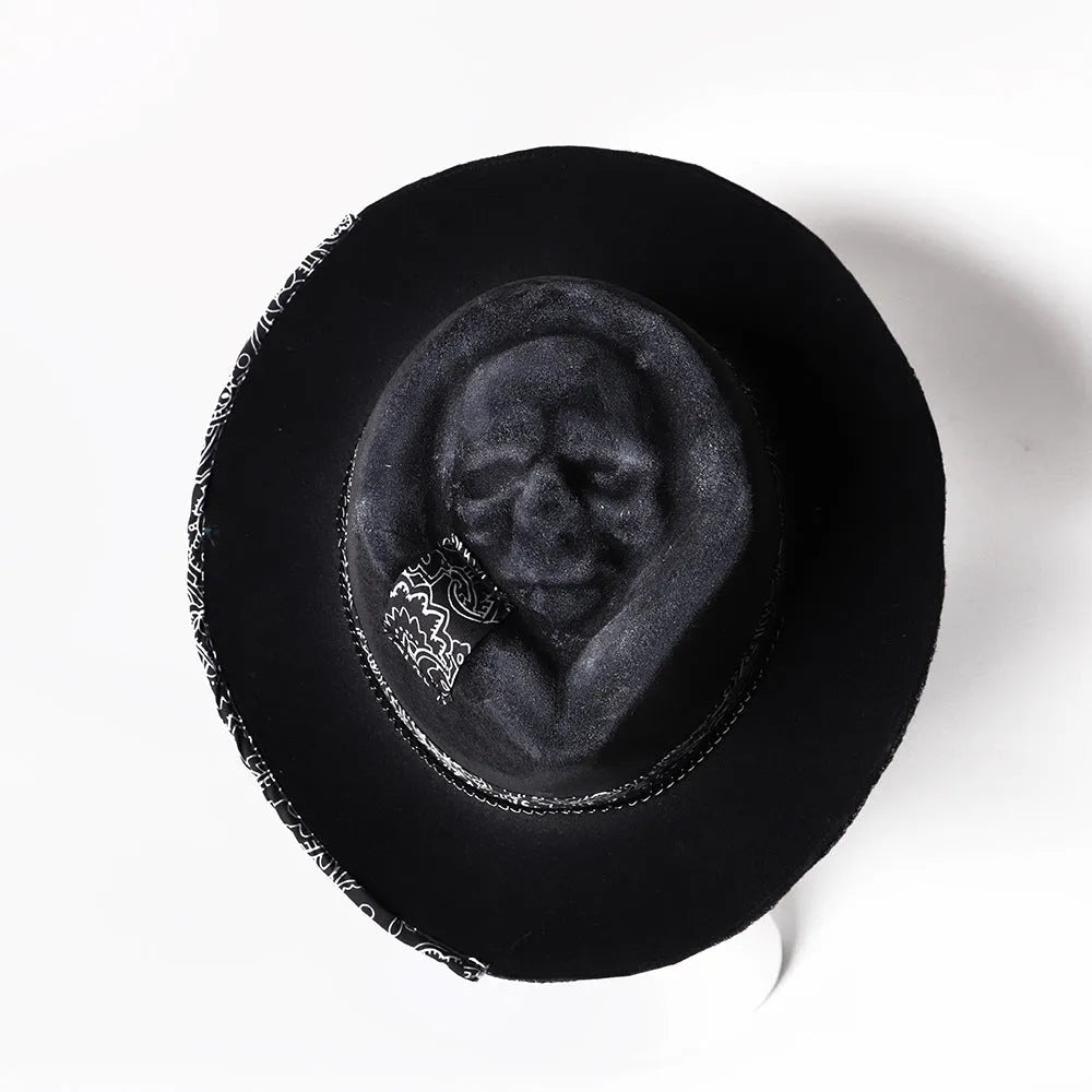 Handmade wool felt skull hat with a conical crown shape on a mannequin head.