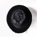 Handmade wool felt skull hat with a conical crown shape on a mannequin head.