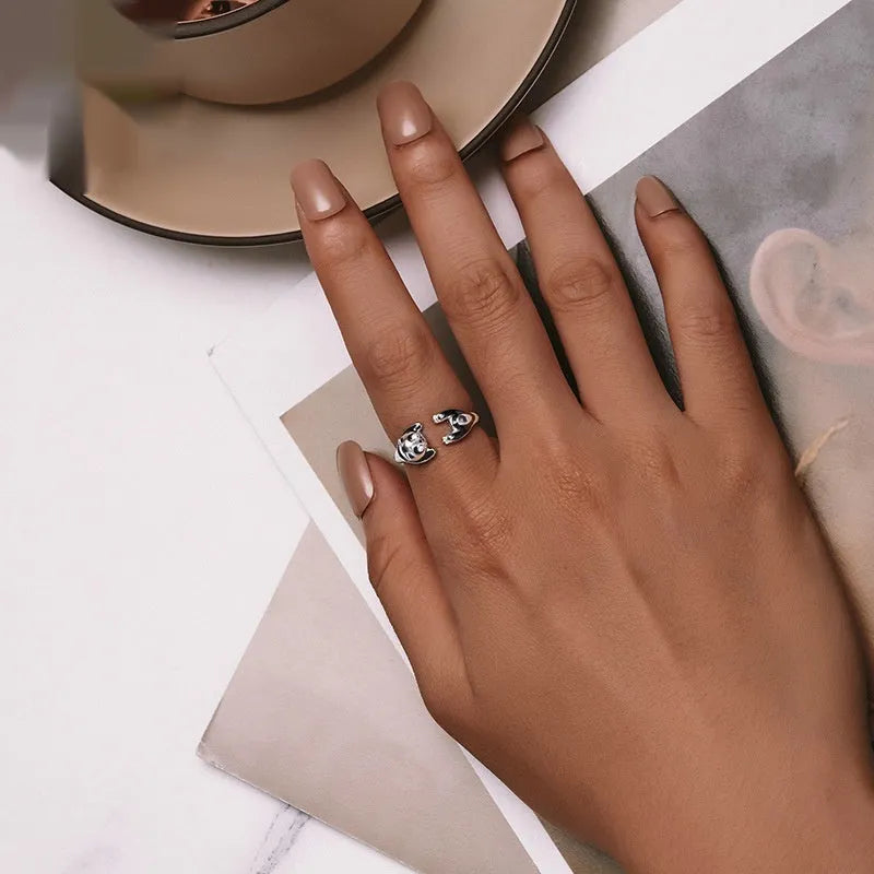 Adjustable sterling silver panda open ring with white gold plating on a finger