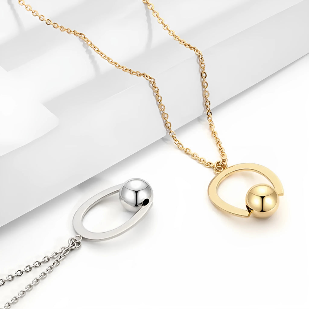 Gold electroplated stainless steel necklace with geometric pendant on an adjustable chain.