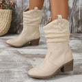 Women's mid-calf suede boots with a pointed toe and short stout heel in lotus root colour.