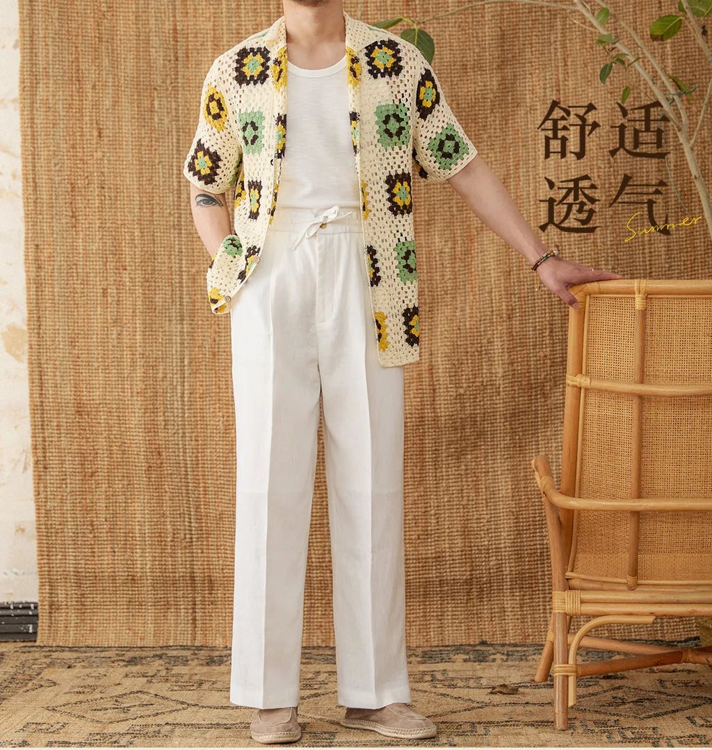 Woman wearing loose-fit linen trousers with a high elasticated waist in a straight-leg cut.