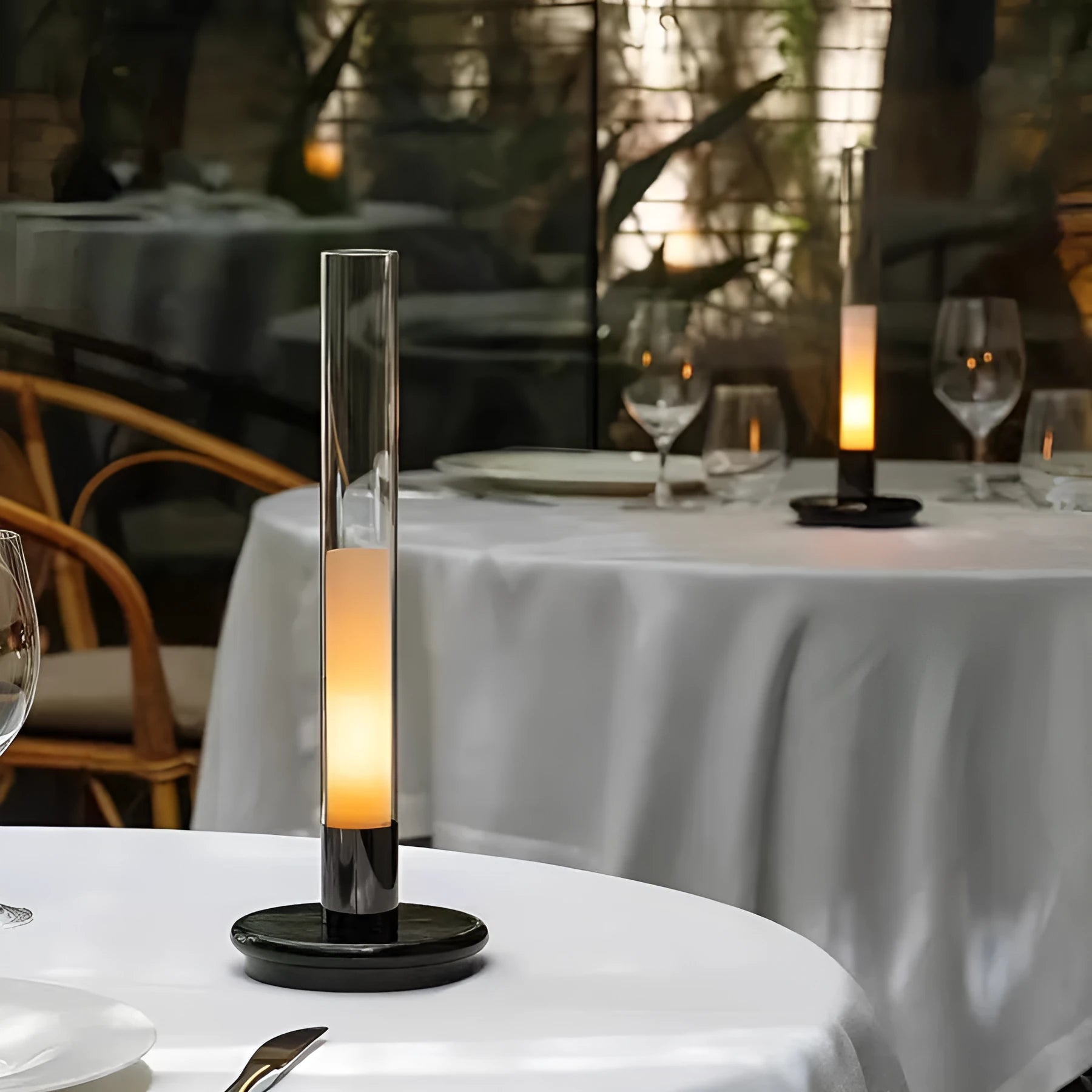 Black Nordic style candlelight table lamp showing three-colour LED light settings on a wooden desk.