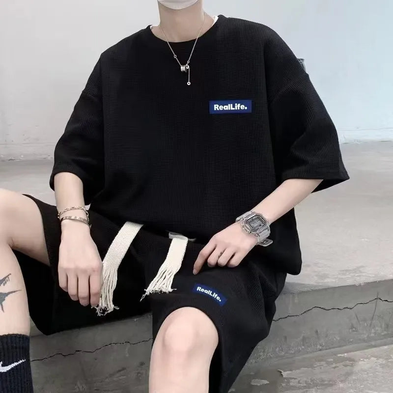 Men's cotton polyester waffle texture short sleeve top and shorts leisure sports suit set on a hanger.