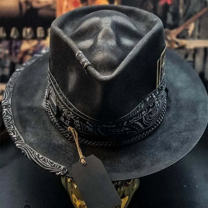 Handmade wool felt skull hat with a conical crown shape on a mannequin head.