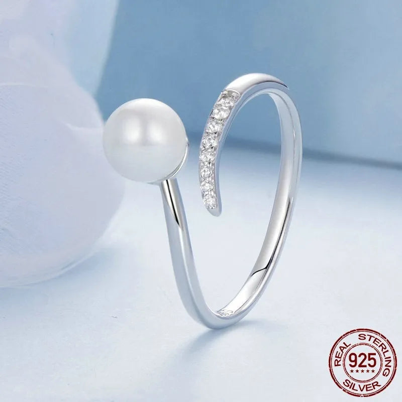 S925 sterling silver adjustable open loop ring with a natural shell pearl on a white background.