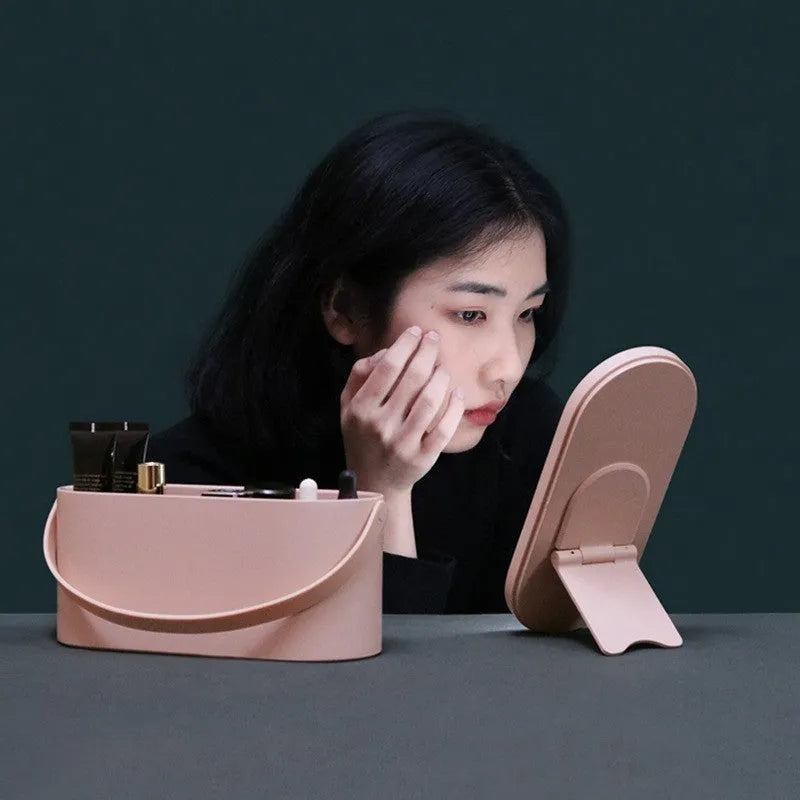 Portable pink and white beauty makeup mirror with storage box.
