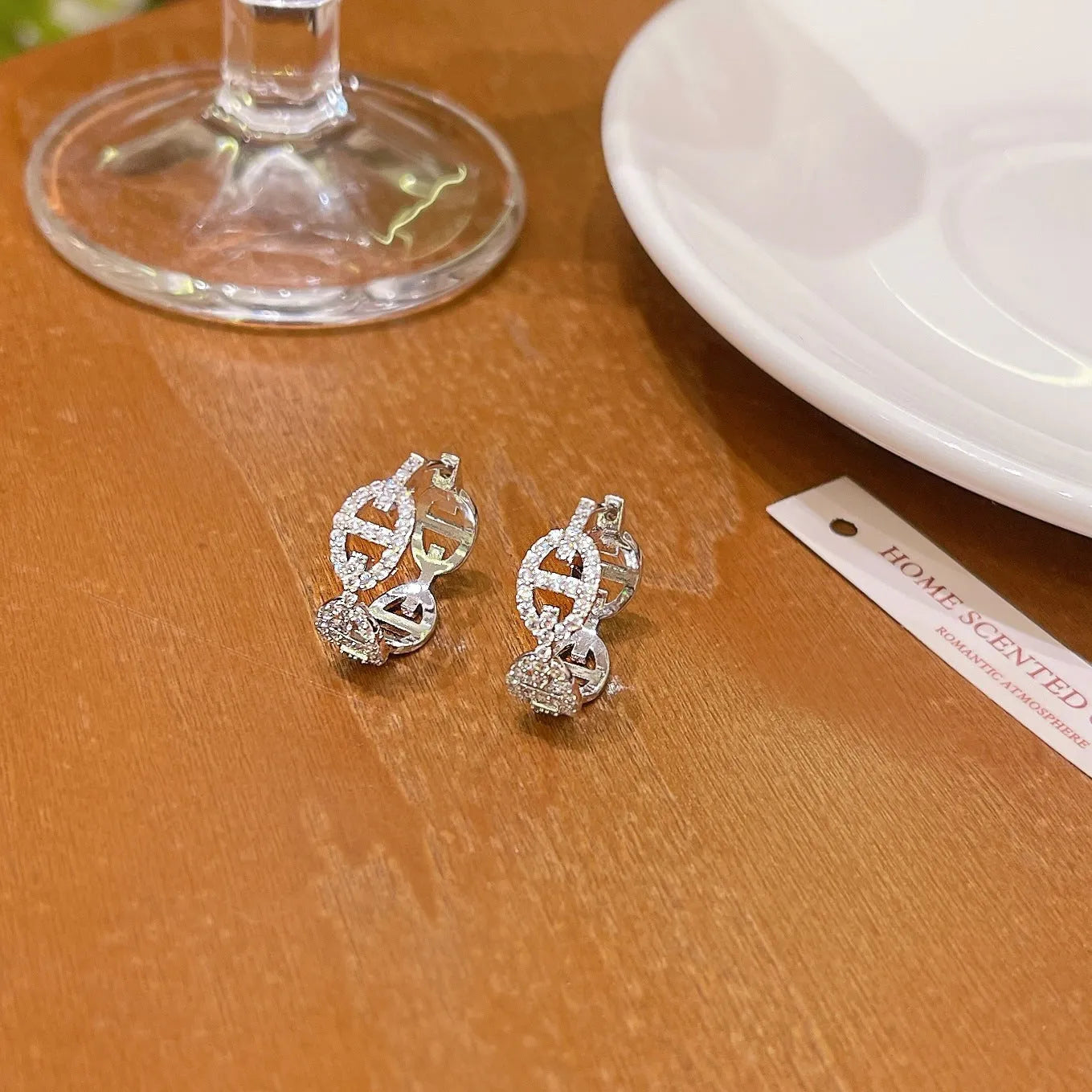 A pair of casual ladies earrings in thick gold plating with a diamond accent, shown in silver, gold, and rose gold colour options