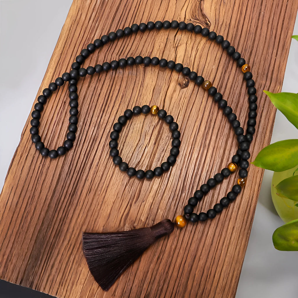 Tiger eye stone beaded necklace and bracelet set with tassel pendants on white background
