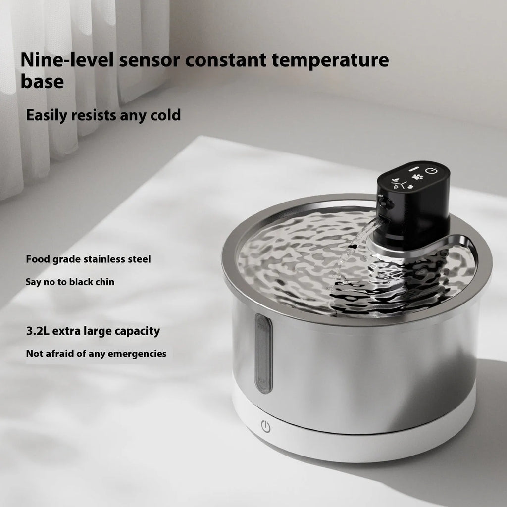 White stainless steel heated pet water fountain for cats and dogs on a countertop.