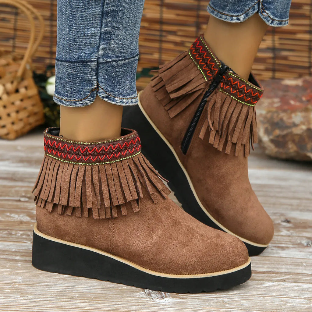 Women's dark brown suede wedge ankle boots with a side zipper and decorative tassels.