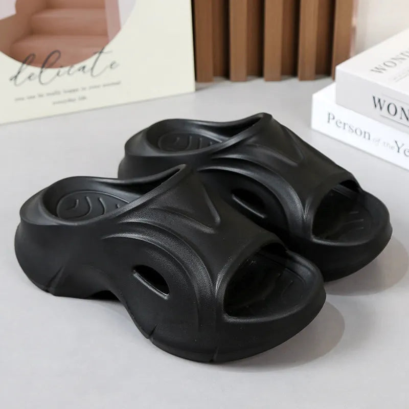 Women's white thick-sole EVA beach slippers with a round toe, shown on a sandy background.