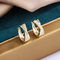 Geometric shape earrings with zircon detail and 14K yellow gold finish on copper