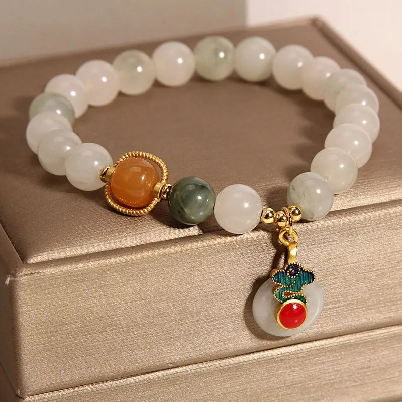 Women's ice jade crystal bracelet with pearl accents and a Xiangyun peace jade buckle.