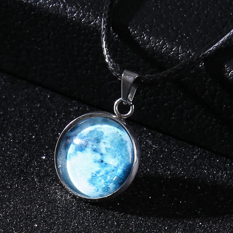 Luminous moon and constellation glass pendant on a silver alloy necklace chain with an extension piece.
