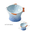 Set of four blue, fish-shaped ceramic cat bowls with a tilted design on a kitchen counter.