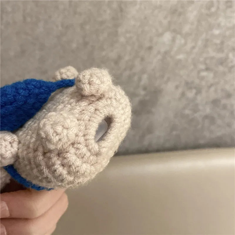 Handmade knitted grey koala bear backpack design cover on an Apple AirPods Pro charging case.