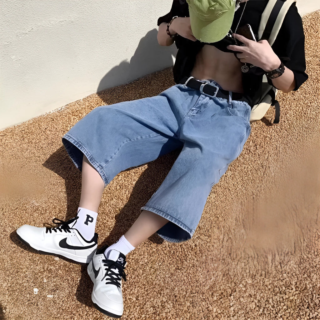 Blue washed denim pirate shorts for men with a high waist, cropped length, and straight legs on a zipper fly.