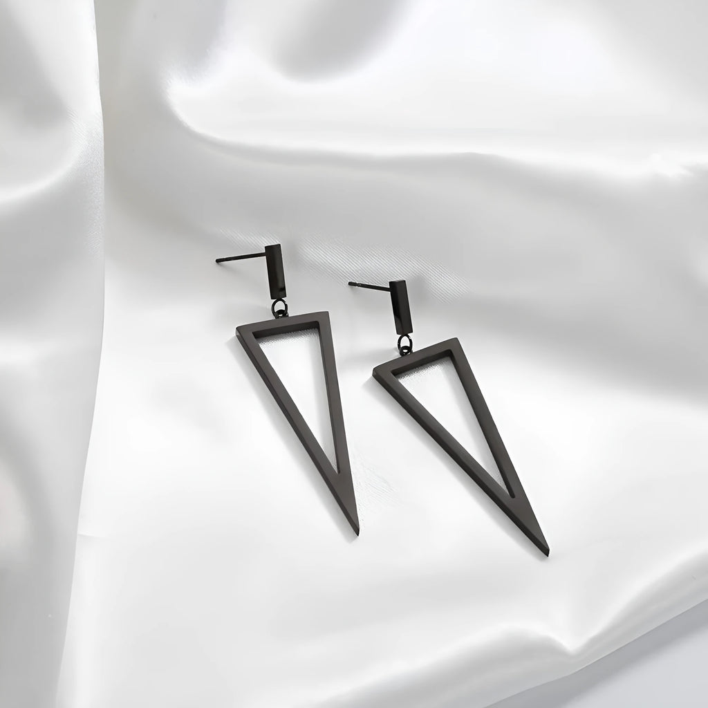 Black metal triangle earrings with electroplated finish on a neutral background