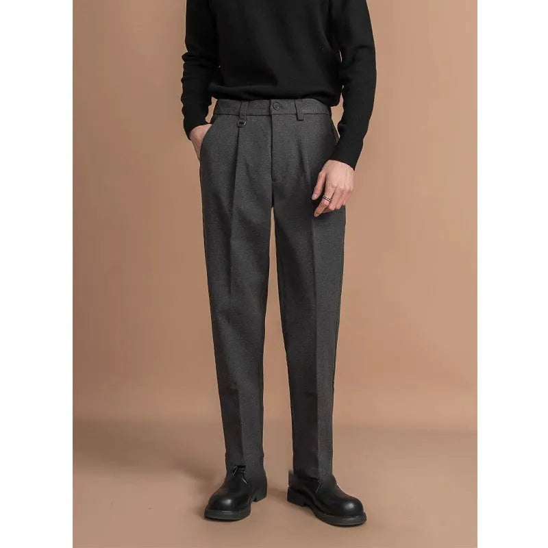 Man wearing straight leg grey suit pants for business casual attire.