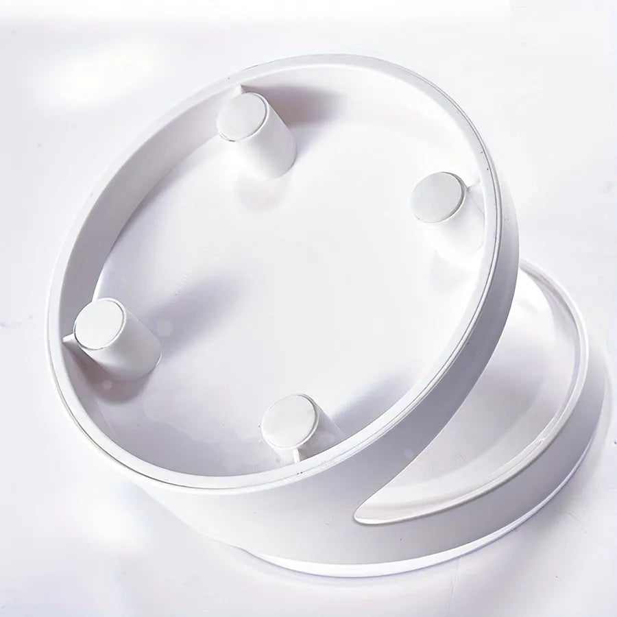 White elevated cat food bowl with a tilted surface on a raised platform.
