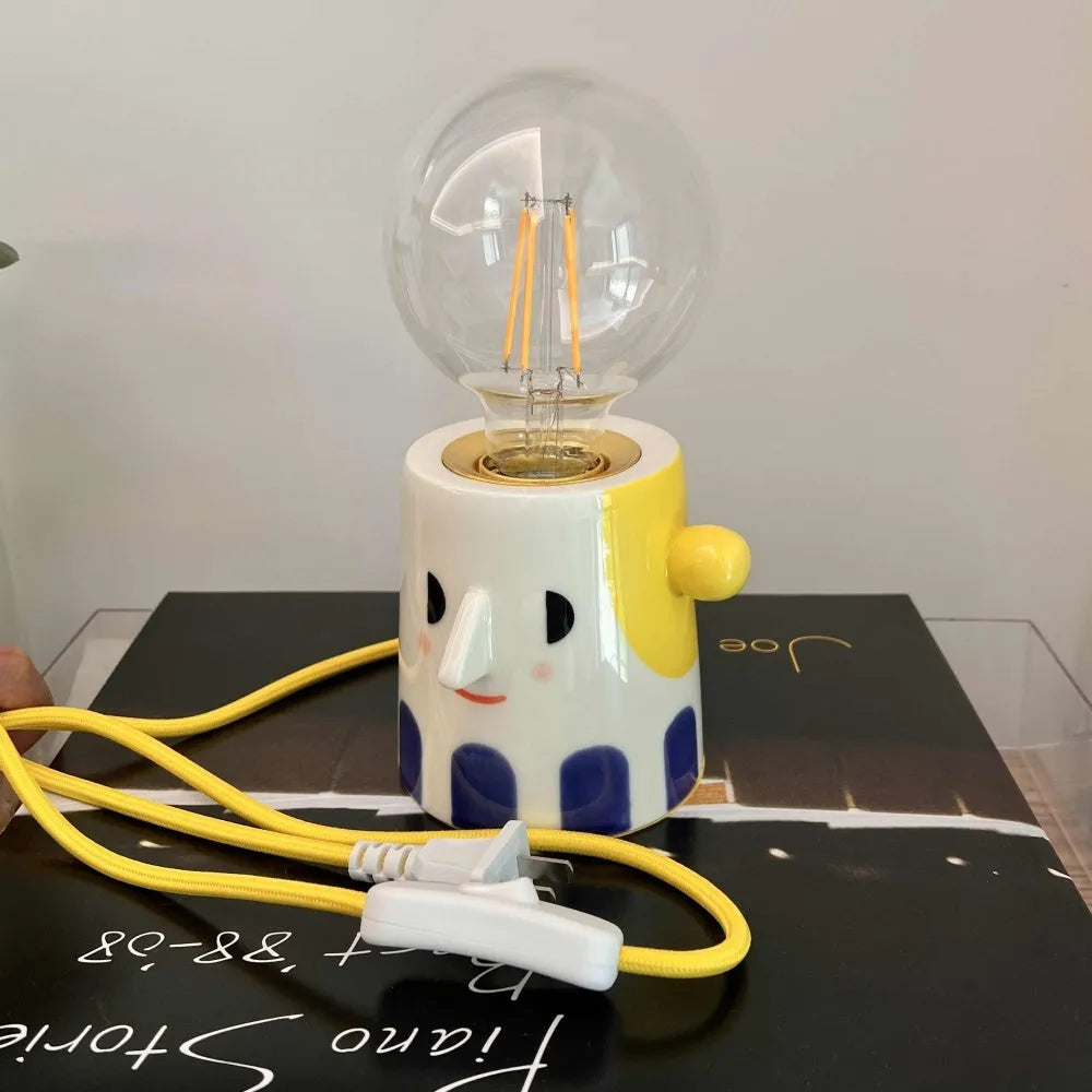 Handmade ceramic table lamp with a spherical ball headlight design on a solid ceramic base.