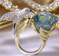 Ocean blue topaz hummingbird shape open ring with real gold colour brass finish and adjustable opening