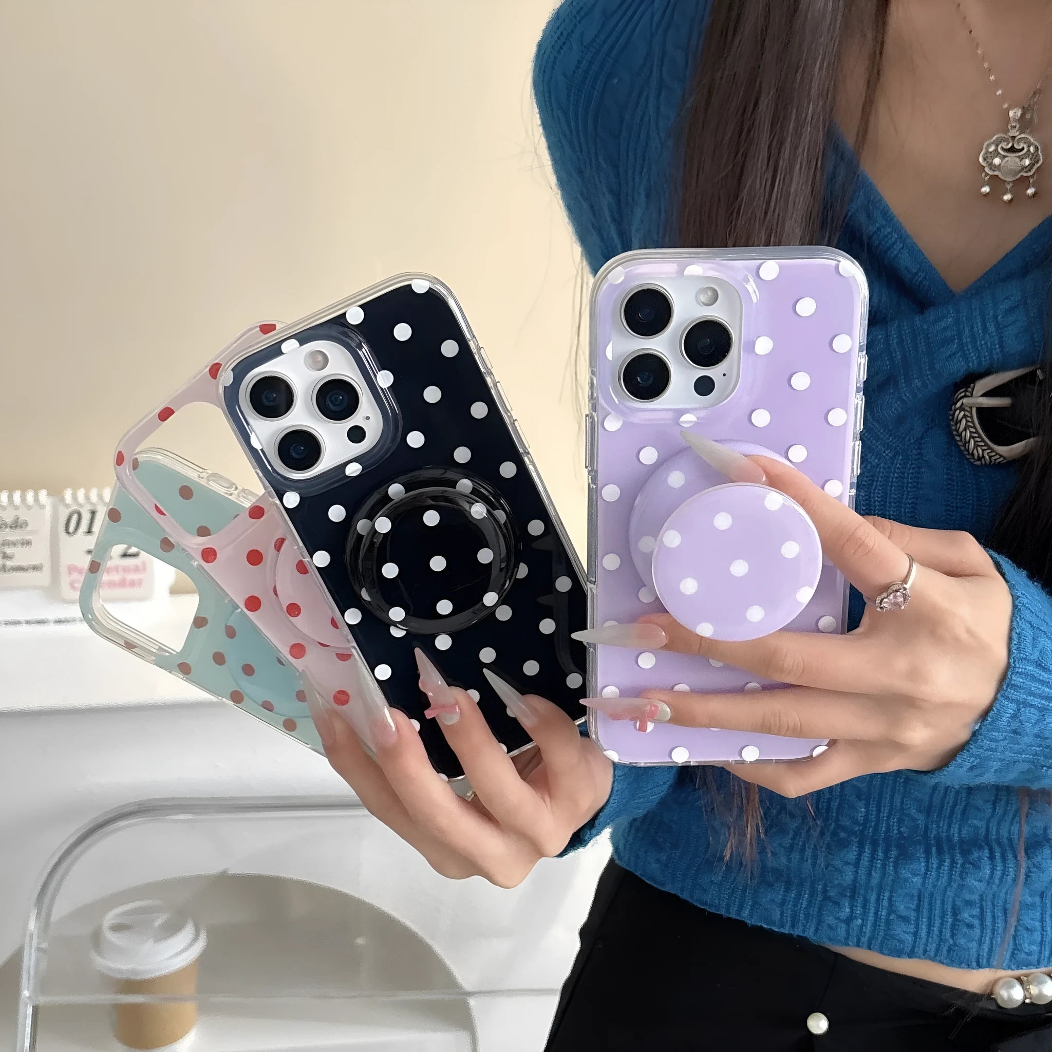 Polka dot phone case with magnetic bracket for iPhone in black showing kickstand