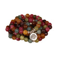 Close-up of a Tourmaline-coloured alloy bracelet with 108 beads and a central hanging lotus decoration.