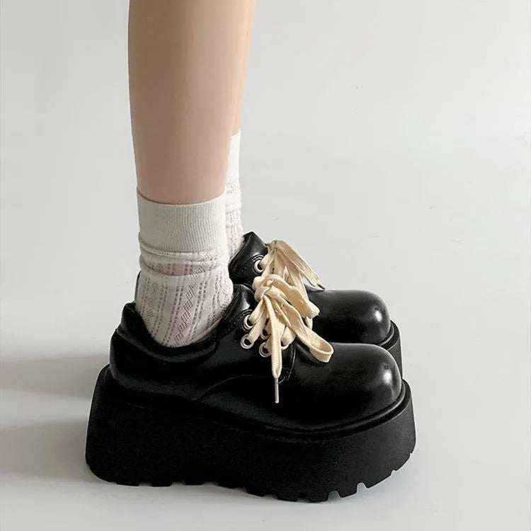 Matte black women's lace-up leather shoes with a thick sole and a chunky heel.
