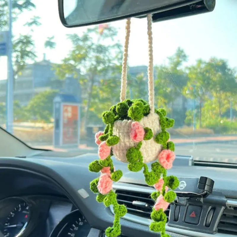 Green and white knitted wool car plant decoration with 8cm base and hanging rope.