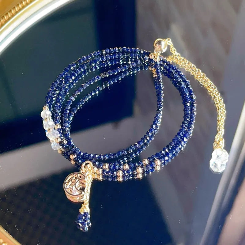 Women's blue sand stone and gold three-ring multi-layer bracelet on wrist