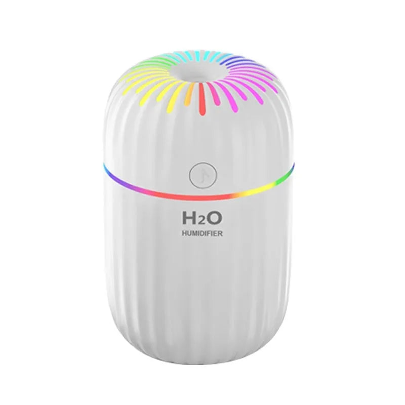 Small white USB portable humidifier with fireworks design on a wooden desk