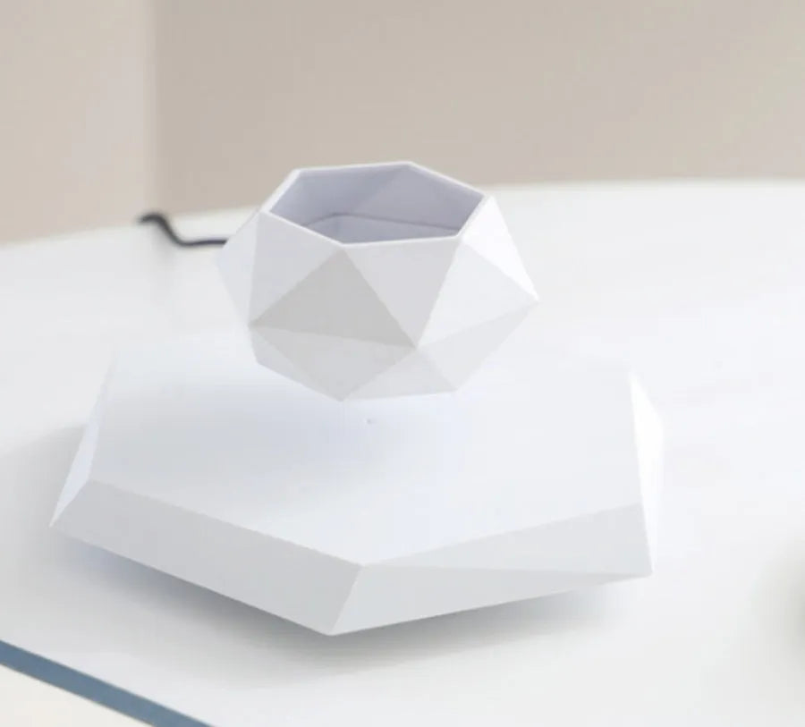 Hexagonal wood grain magnetic levitating flower pot floating above base