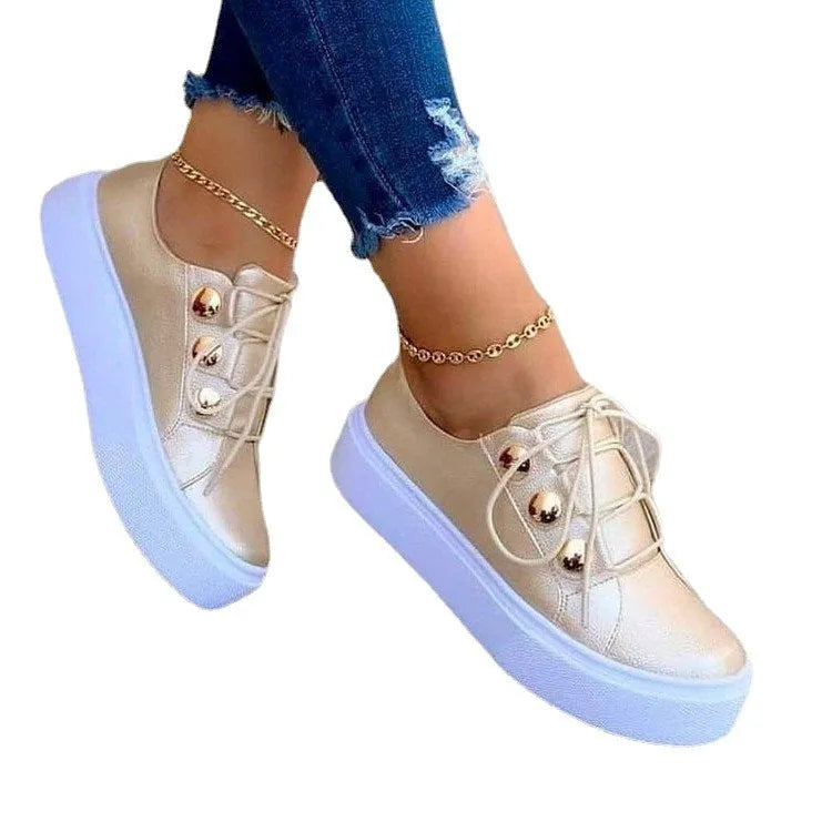 Women's white lace-up flats sneakers with round toe and decorative silver rivet details on the artificial PU upper.