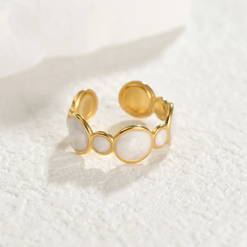 Silver geometric ring with an adjustable opening on a plain background