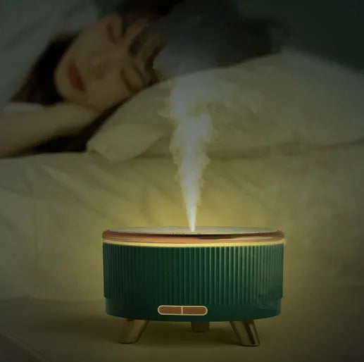 Cylinder plastic USB humidifier in black with 500ml tank and single fog outlet on a bedside table