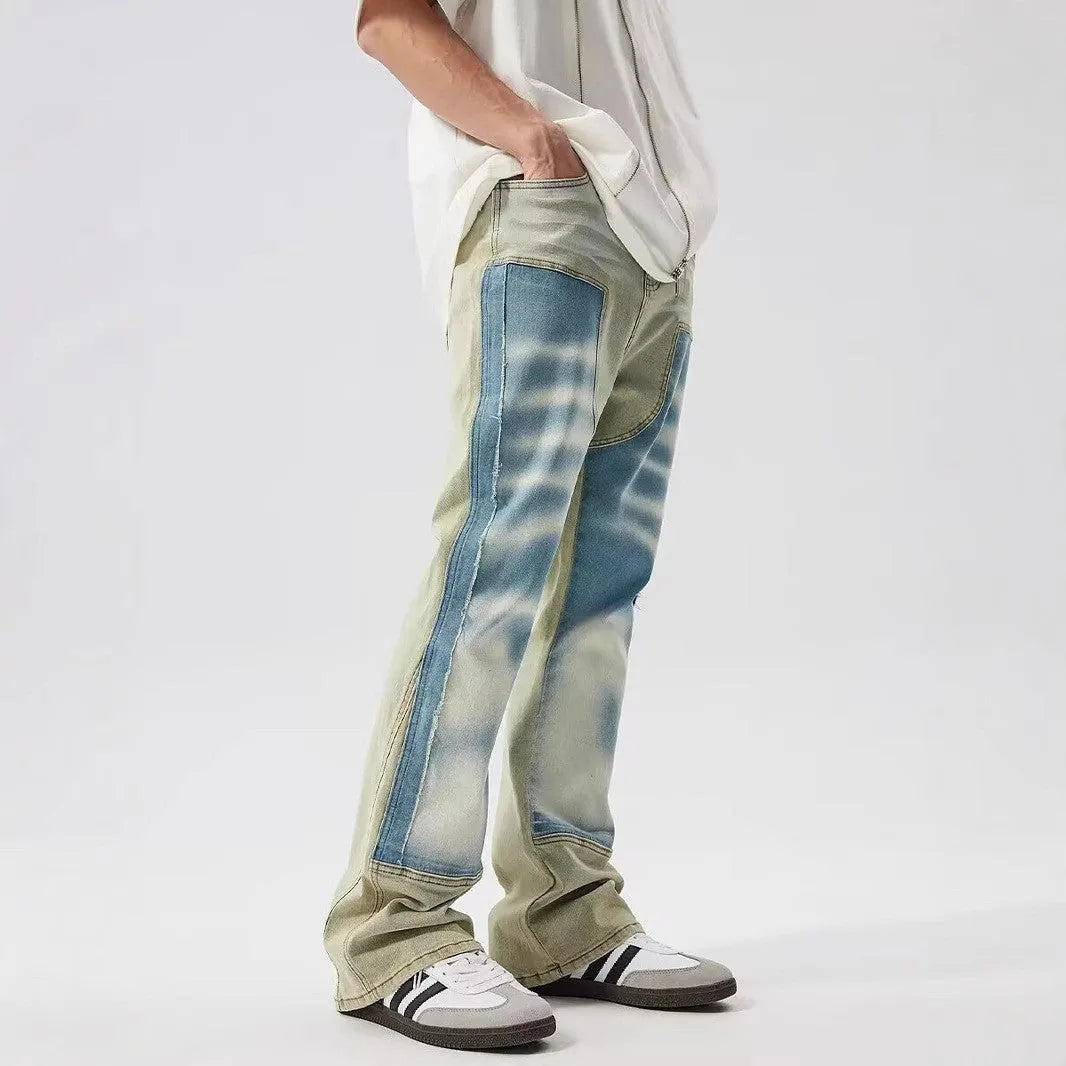 Yellow and blue retro patchwork jeans with splash-ink damaged design and zip fly.
