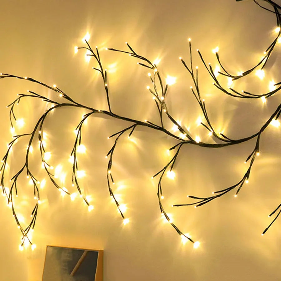 Flexible willow vine LED garland with warm white lights and white birch bark texture, bent into a decorative shape.