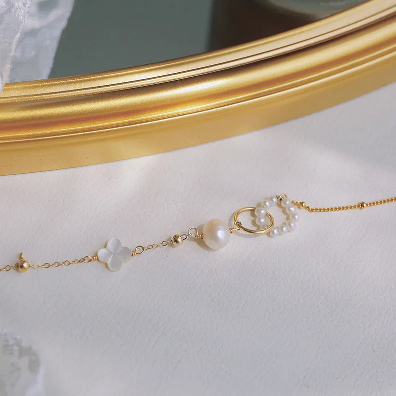 Women's natural pearl bracelet with 14k gold-plated setting.