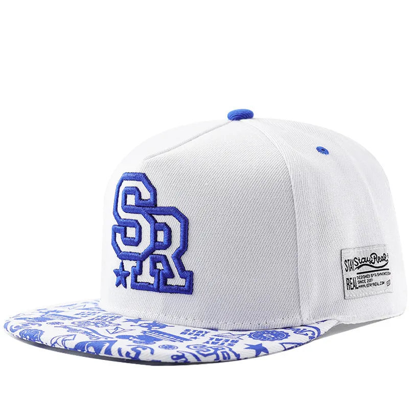 Black and white cotton baseball cap with embroidered letter design on the front.