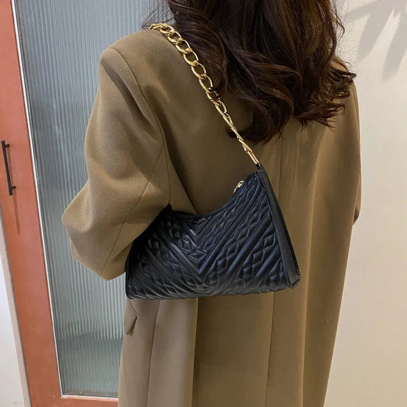 Brown pleated chain baguette shoulder bag showing vertical square shape and soft carry handle