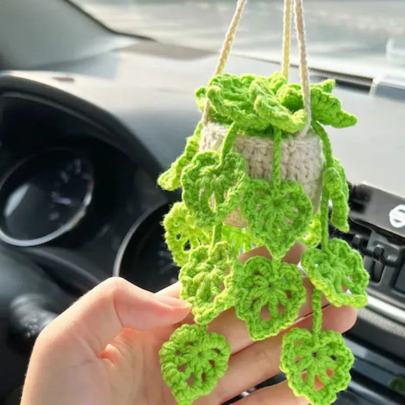Green and white knitted wool car plant decoration with 8cm base and hanging rope.