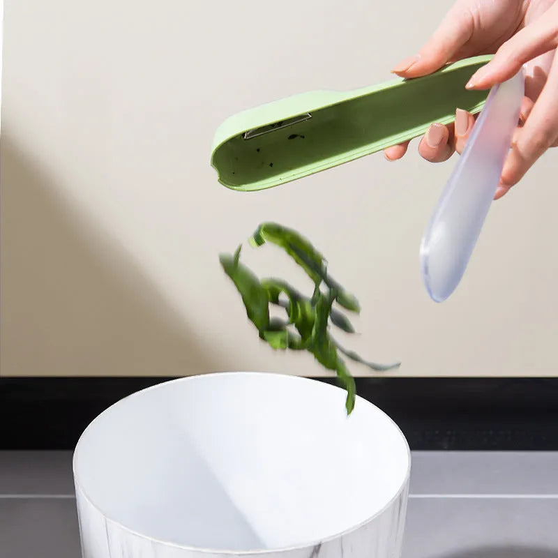 Dark green kitchen peeler with storage tube and stainless steel blade for vegetables
