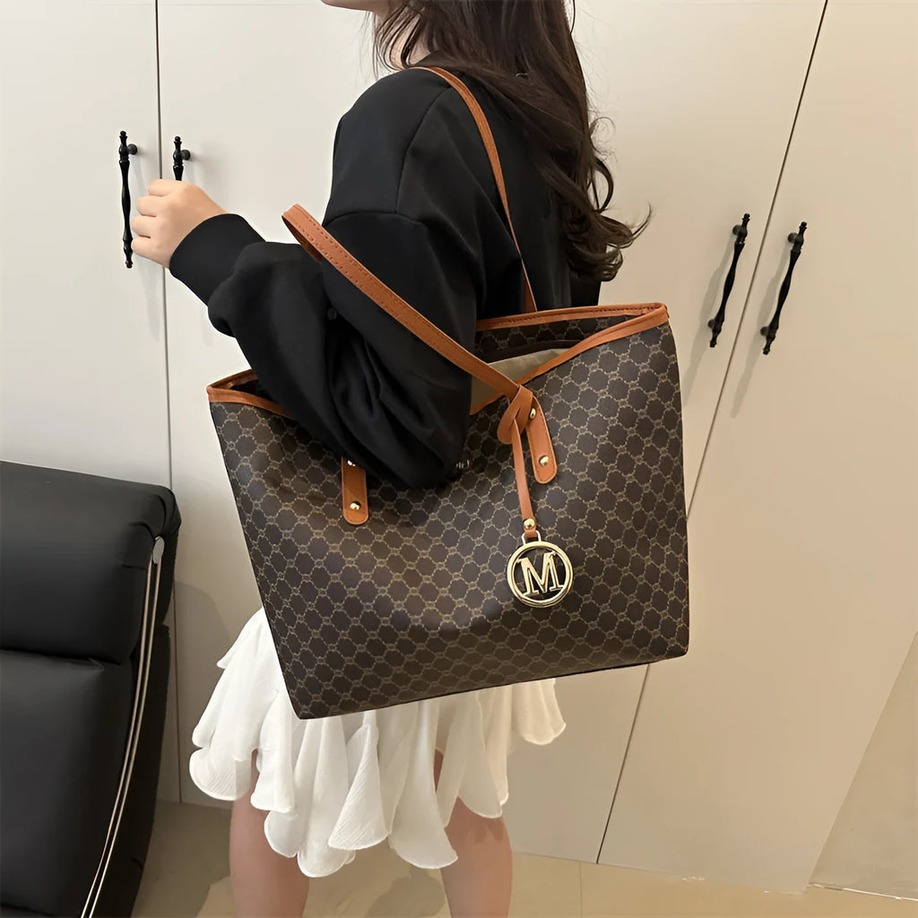 Soft PU leather ladies' shoulder bag in black showing contrast stitching and a top handle.