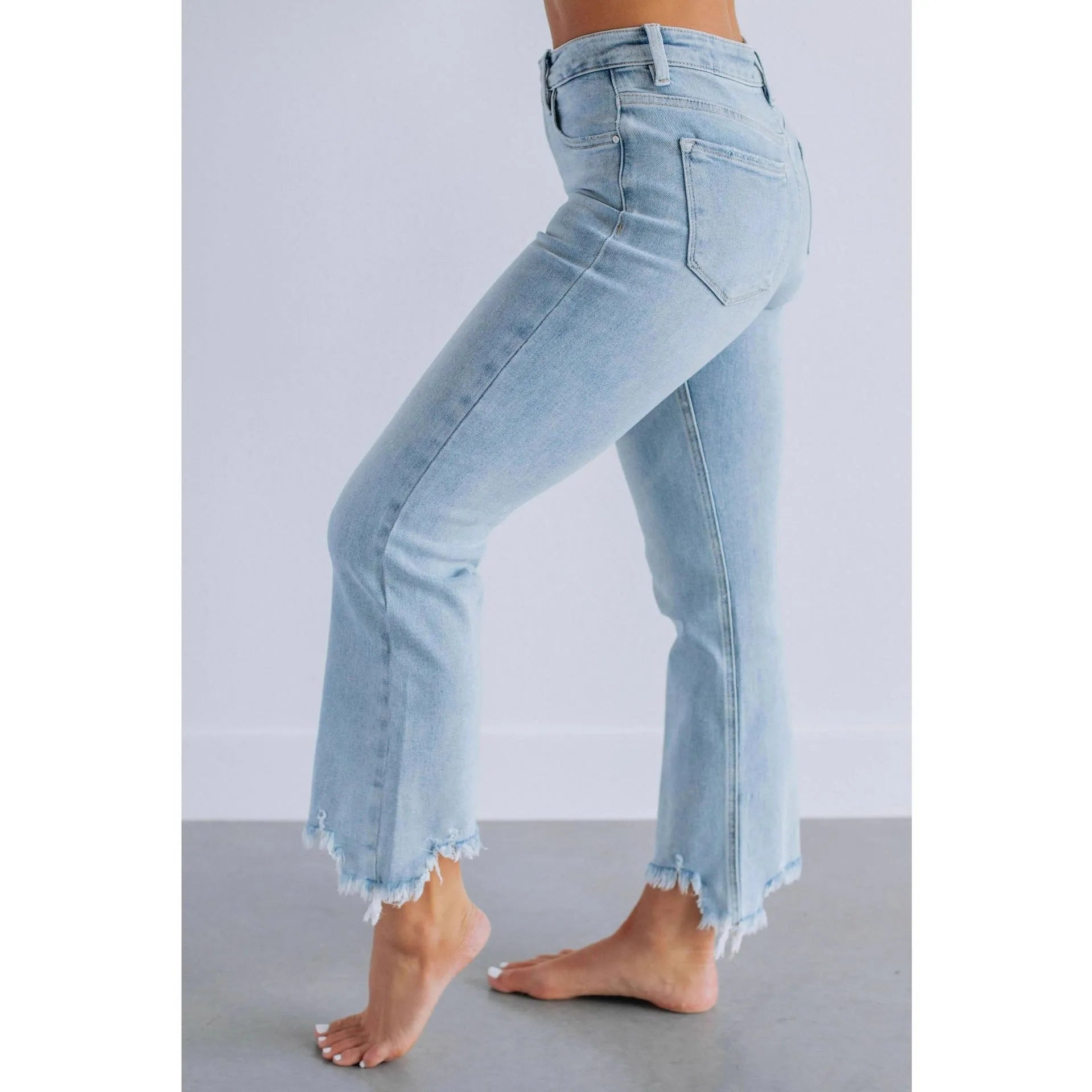 Women's solid blue casual denim trousers with a hand-worn finish on a hanger.