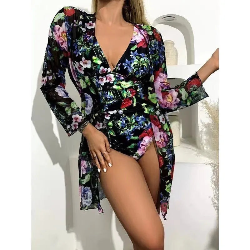 Women's floral patterned tight bikini three-piece swimsuit set with a coat on a hanger.