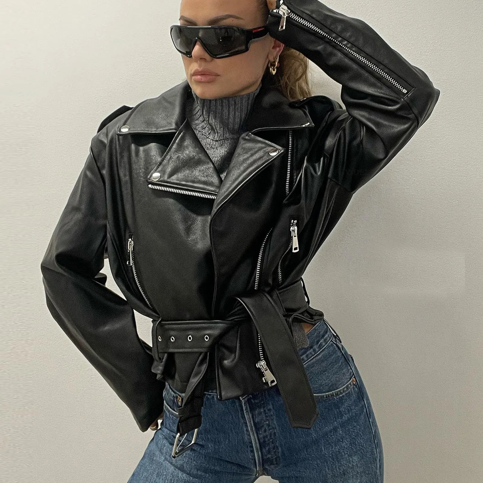 Punk short black jacket with lapel, belt, and Peter Pan collar on a model.