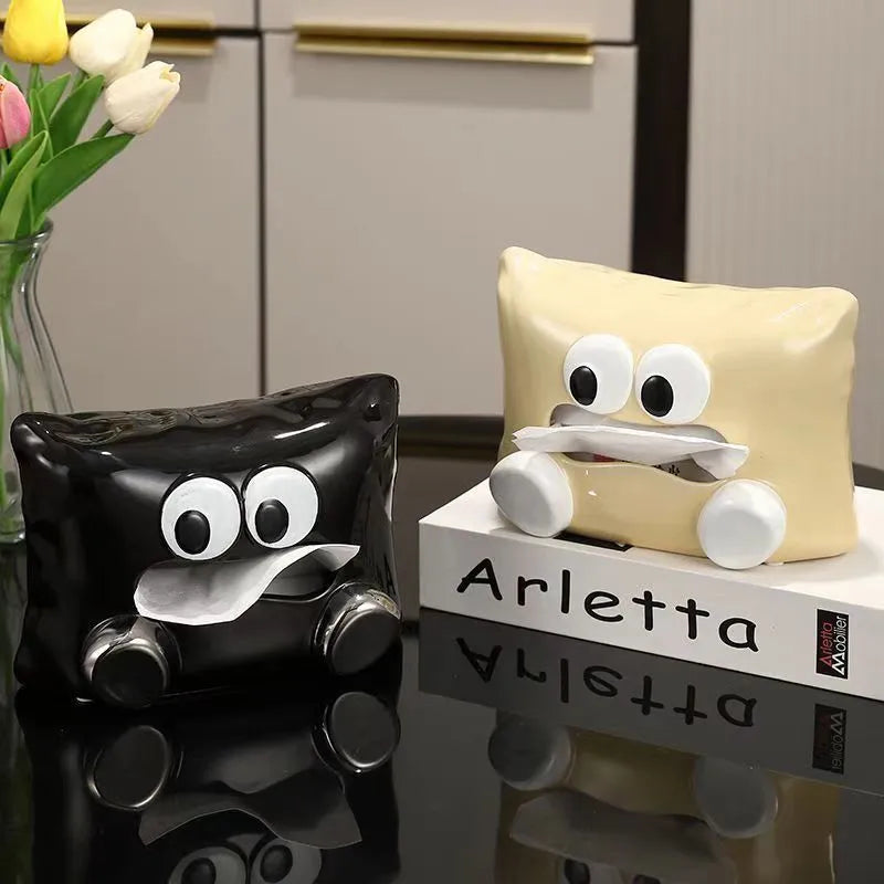 White ceramic tissue box holder on a wooden table.